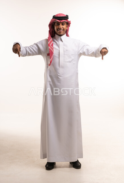 Saudi Man in Traditional Dress Pointing Downwards