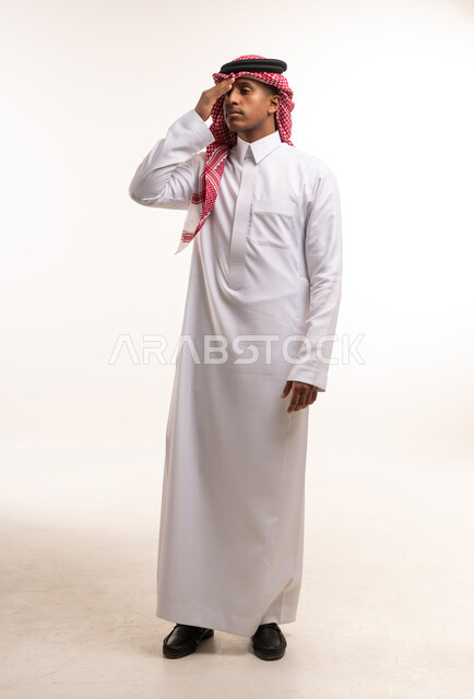 Saudi Man in Traditional Thobe Saluting on White Background