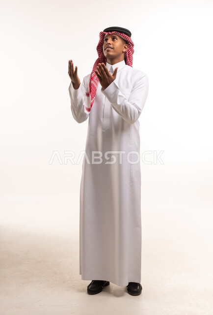 Saudi Man in Traditional Thobe Praying on White Background