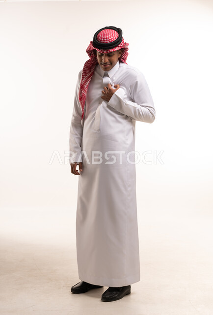 رجل سعودي بالزي التقليدي الثوب والشماغ في الاستوديو