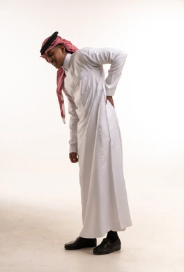 Saudi Man with Back Pain in Traditional Thobe