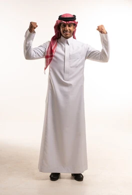 Saudi Man in Traditional Thobe Flexing Biceps in Studio