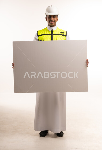 Saudi Engineer in Safety Gear Holding Blank White Sign