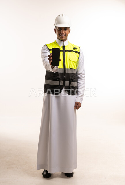 Saudi Site Engineer Holding Smartphone in Studio