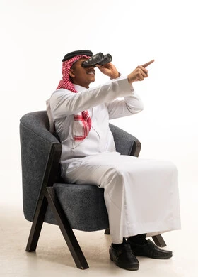 Saudi Man in Traditional Thobe Looking Through Binoculars