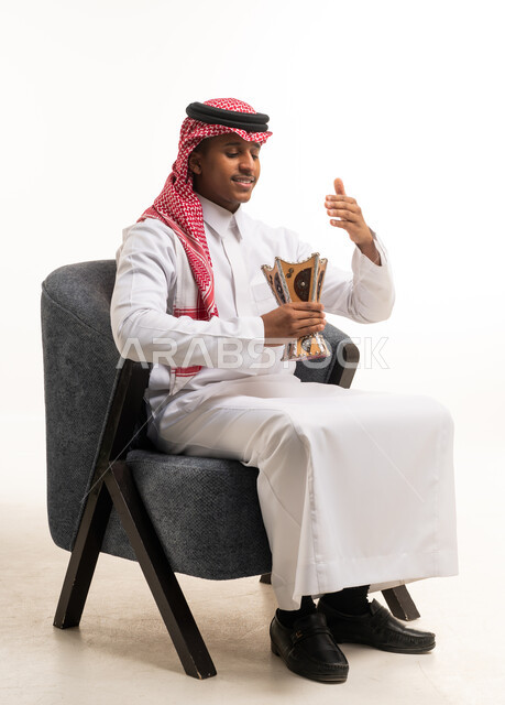 Saudi Man in Traditional Thobe Holding Incense Burner