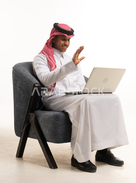 Saudi Man in Thobe Using Laptop Video Call