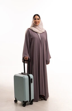 امرأة عربية مع حقيبة سفر على خلفية بيضاء