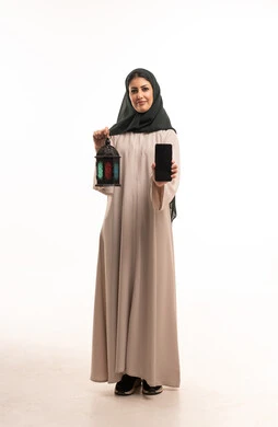 Saudi Woman Holding Ramadan Lantern and Smartphone
