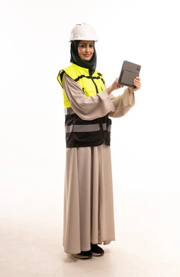 مهندسة سعودية ترتدي خوذة وسترة سلامة وتستخدم تابلت