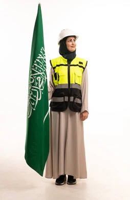 Saudi Woman Engineer Holding Saudi Flag in PPE