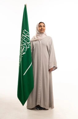 Saudi Woman in Traditional Abaya with National Flag