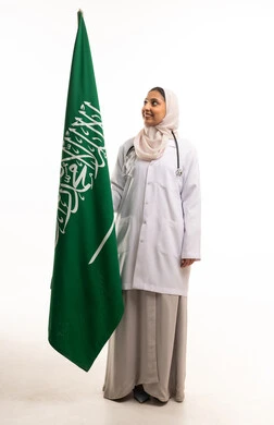Saudi Female Doctor Holding National Flag in Studio