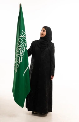 Saudi Woman Holding Saudi Arabia Flag in Studio