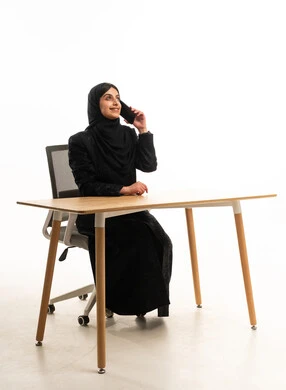 Arab Woman in Black Abaya Talking on Phone at Office Desk