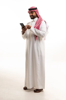 Saudi Man in Traditional Thobe Using Smartphone Studio