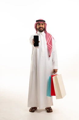 Saudi Man Holding Smartphone and Shopping Bags in Studio