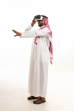 A Saudi man uses virtual reality glasses in the studio.