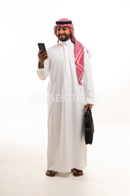 Saudi Businessman with Smartphone and Briefcase