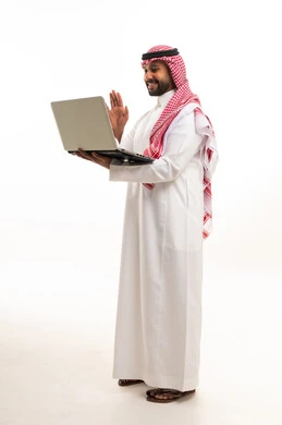 A Saudi man in traditional attire using a mobile phone against a white background.