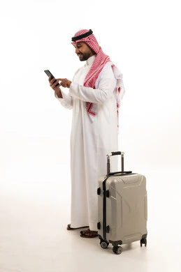 Saudi Man with Suitcase Using Smartphone on White Background