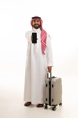 A Saudi man with a suitcase and a smartphone on a white background.