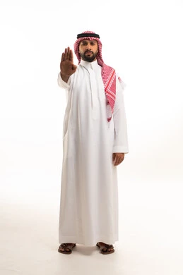 Saudi Man in Traditional Thobe Making Stop Gesture