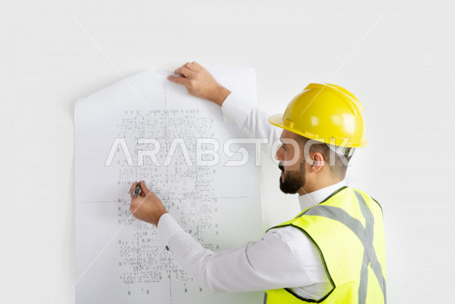Portrait, Saudi Arabian engineer, skilled engineer in blueprints, Gulf man engineer, white background