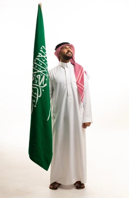 Saudi Man Holding National Flag on White Background