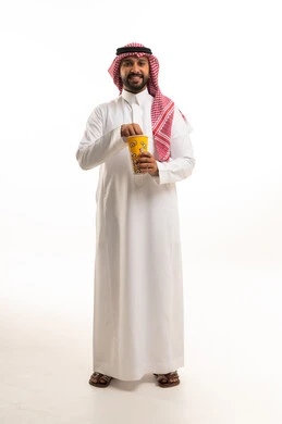 Smiling Saudi Man in Traditional Thobe Eating Popcorn
