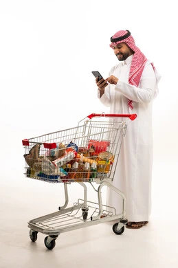 Saudi Man with Grocery Shopping Cart and Smartphone