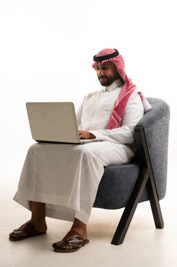 Saudi Man Using Laptop in Traditional Attire