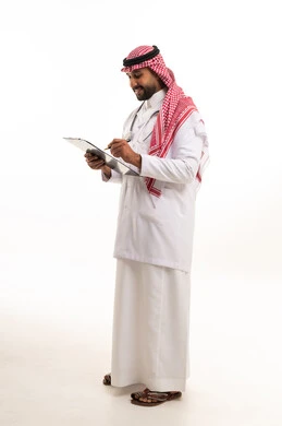 Saudi Male Doctor Writing on Clipboard in Studio