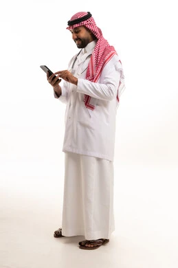 Saudi Male Doctor Using Smartphone in White Lab Coat