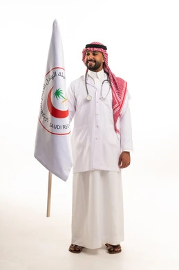 A Saudi doctor holding the Red Crescent flag on a white background.