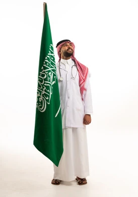 Saudi Male Doctor Standing with Saudi Flag