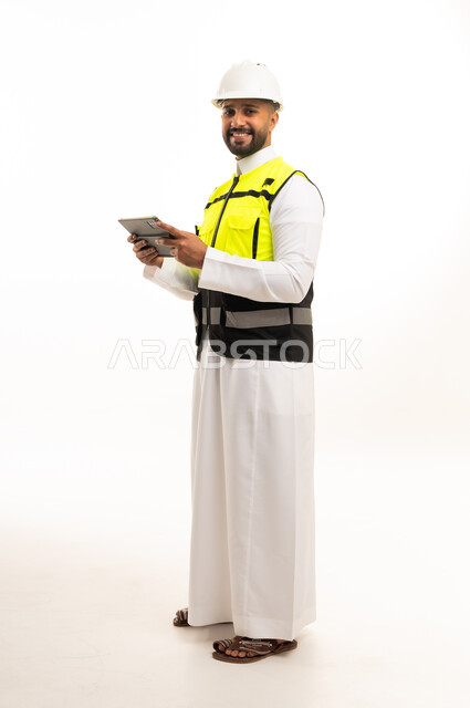 Saudi Engineer Holding Digital Tablet in Safety Gear