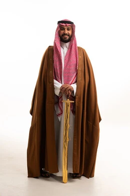 Saudi Man in Traditional Bisht Holding Golden Sword
