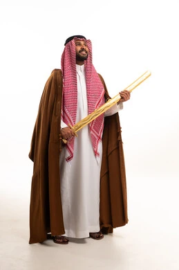 Saudi Man in Traditional Dress Holding Ceremonial Sword