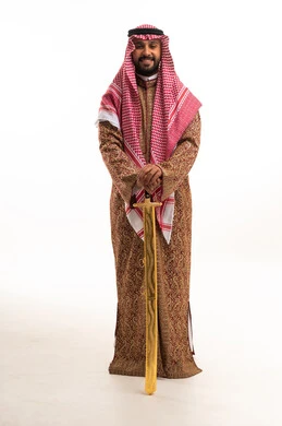 Saudi Man in Traditional Daqlah Holding Golden Sword