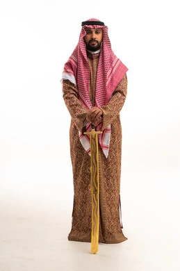 Saudi Man in Traditional Dress Holding Gold Sword