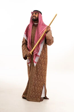 Saudi Man in Traditional Dress with Golden Sword