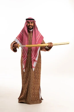 Saudi Man in Traditional Dress Holding a Sword