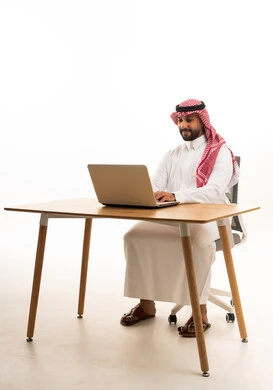 Saudi Man Working on Laptop at Office Desk
