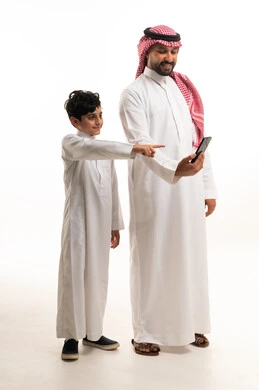 Saudi Father and Son Using Smartphone on White Background