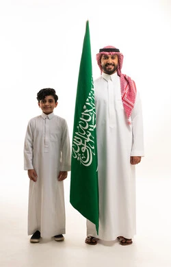 Saudi Man and Child with Flag on White Background