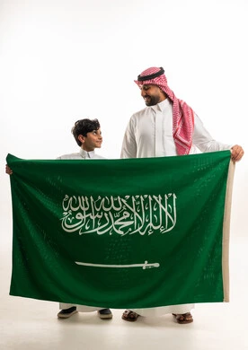 Saudi Man and Boy Holding Saudi Arabia Flag