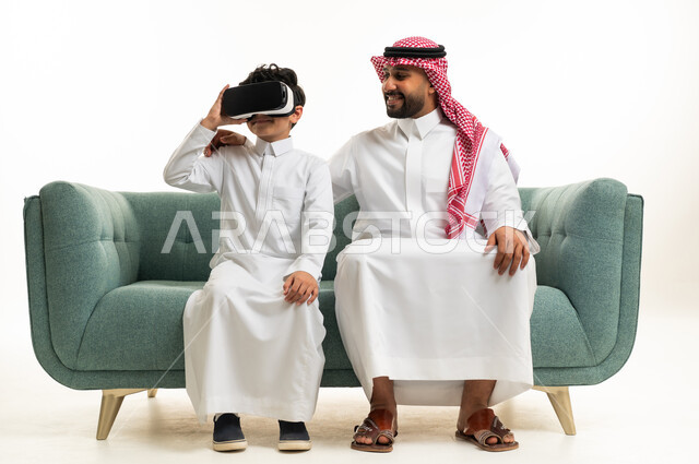 Saudi Man and Boy with VR Headset on Sofa