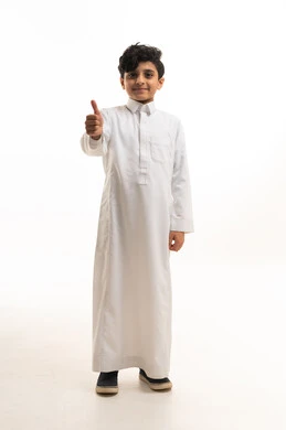 Saudi Boy in Traditional White Thobe Giving Thumbs Up