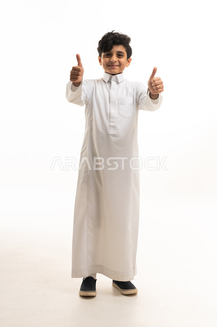 Saudi Boy in Traditional Thobe Giving Thumbs Up